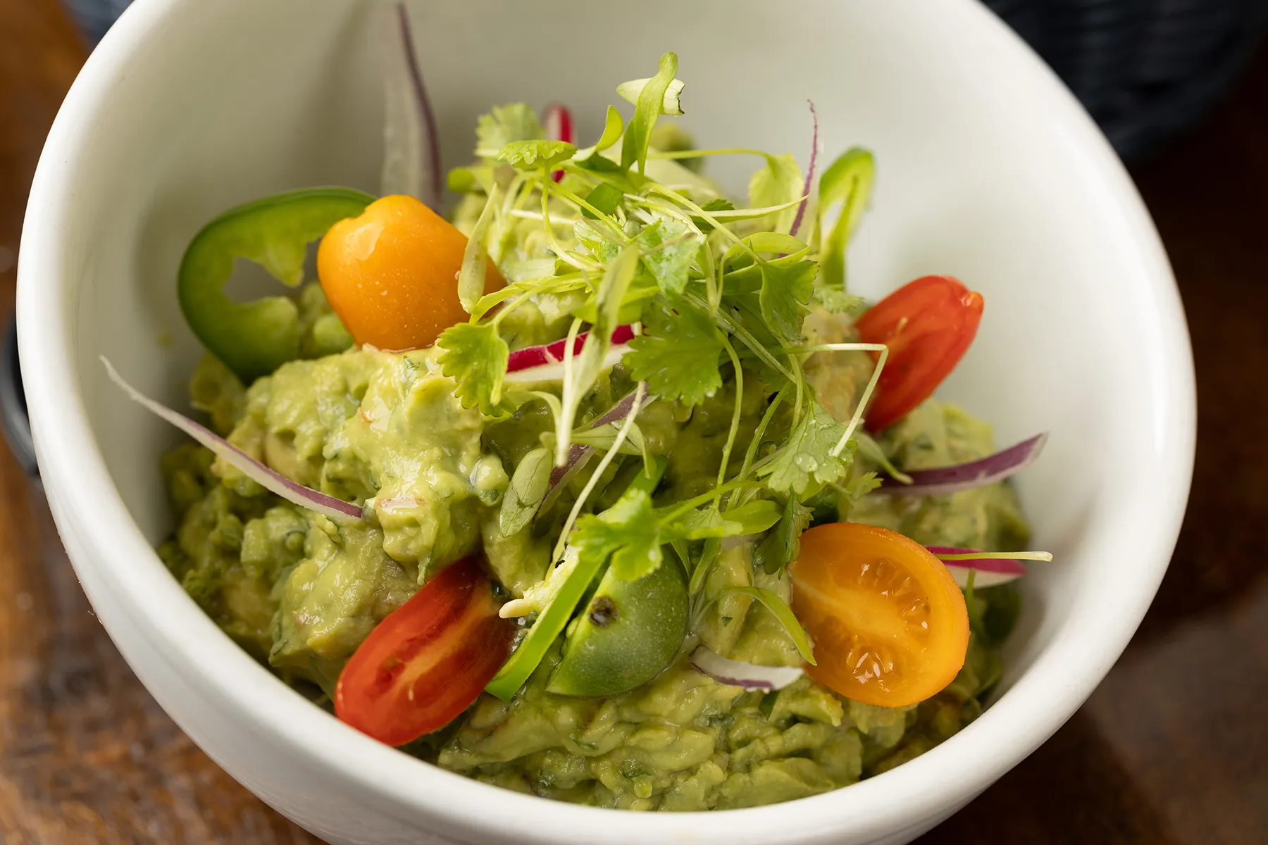 green salad with tomatoes and guacamole