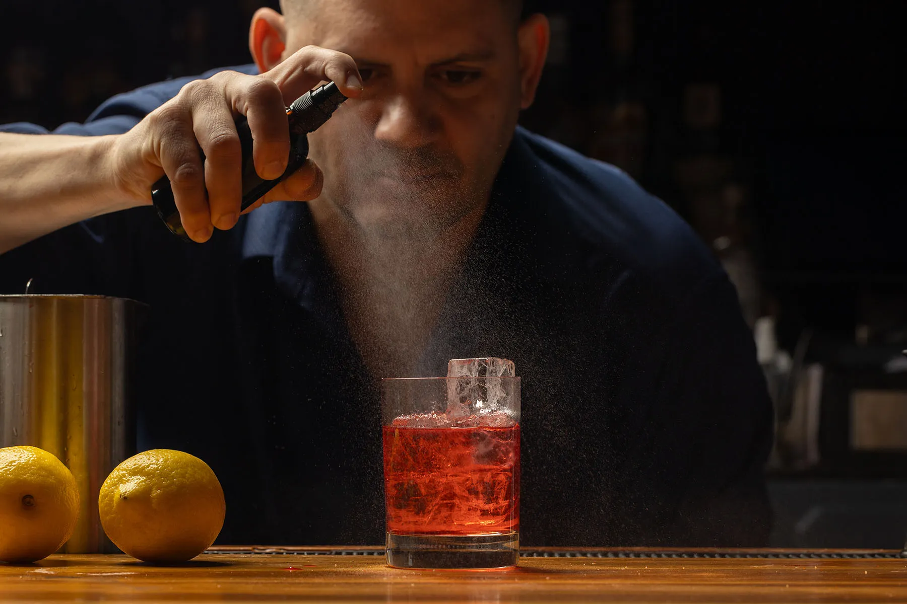 red craft cocktail on the bar.